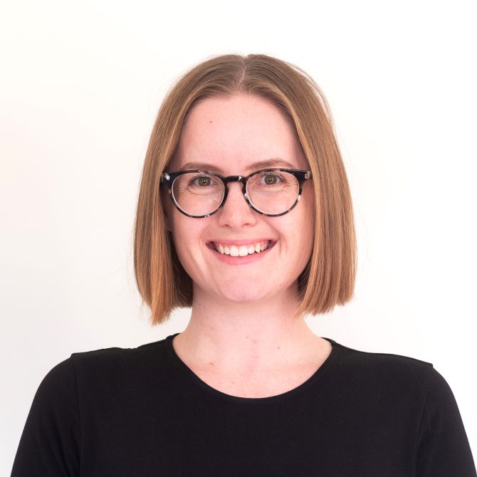 Melissa, a smiling woman wearing glasses and a black shirt